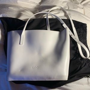 loq white purse with unique strap detailing